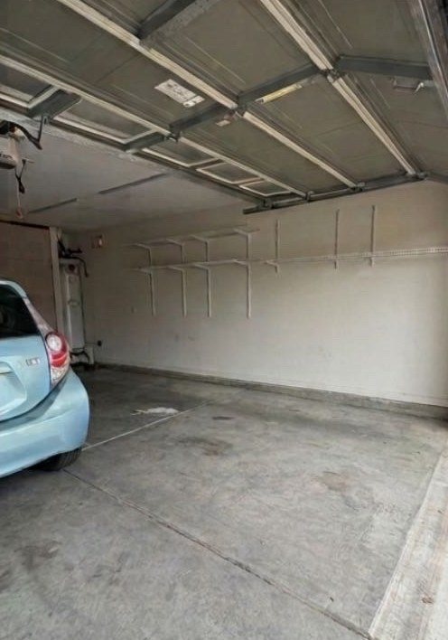 The same garage emptied, with a car parked inside after the cleanout