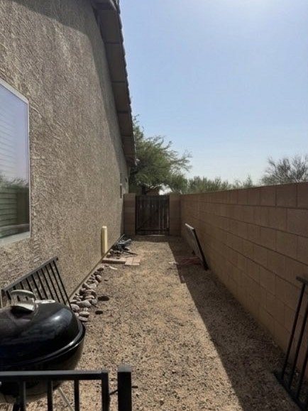 The same side yard cleared and swept with clean gravel visible